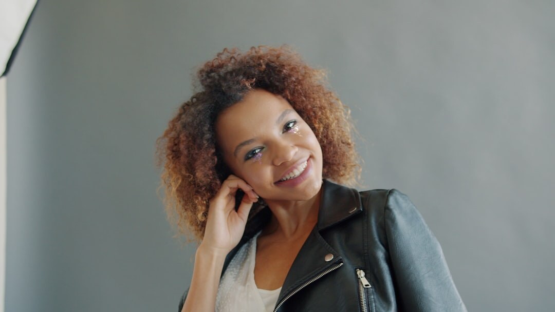 Confident female TV host smiling in a studio
